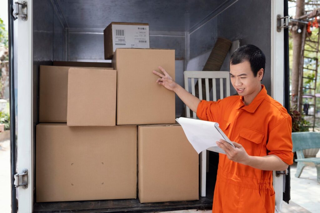 young-man-checking-details-parcels-before-delivery