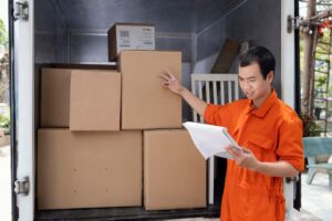 young-man-checking-details-parcels-before-delivery